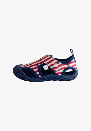 Children's closed-toe sandal with red and white stripes, navy blue anchors, mesh sides, and a Velcro strap on a textured sole.