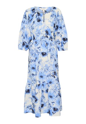 Cvetna maksi obleka v modri in beli barvi z večnivojsko obrobo. Ima okroglo izrez, rukavov do tri četrtine in zavezan pas za prilegačen videz.