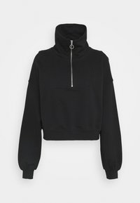 Sweat-shirt noir court avec col montant, fermeture éclair frontale et manches longues. Texture douce avec un design minimaliste, sans motifs ni graphiques.