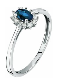 Ovaler blauer Edelsteinring aus Silber, umgeben von einer Gruppe kleiner klarer Steine in der Mitte, mit einem glatten, polierten Band.