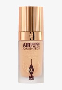 Air Brush Flawless Foundation in a clear glass bottle with a gold textured cap. Features dark lettering and decorative wing motifs.
