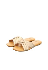 Tan slide sandals with crisscross leather straps, cushioned footbed, flat sole, and subtle logo on the side. Smooth texture and open-toe design.