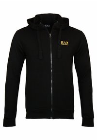 Black zip-up hoodie made of smooth fabric, featuring a drawstring hood and golden EA7 logo on the left chest. Long sleeves with ribbed cuffs.