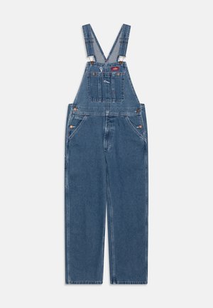 Denim overalls in dark blue with adjustable shoulder straps, front pocket, and side buttons. Features wide leg fit and classic stitching details.