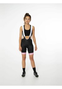 Pantaloni bib neri da ciclismo con accenti rosa e bretelle bianche. Progettati con ritagli per la ventilazione e un sedile imbottito per il comfort.