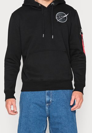Haut à capuche noir avec un logo de la NASA sur la poitrine, capuche avec cordon de serrage, poche kangourou à l'avant et une bande d'accent rouge sur la manche.