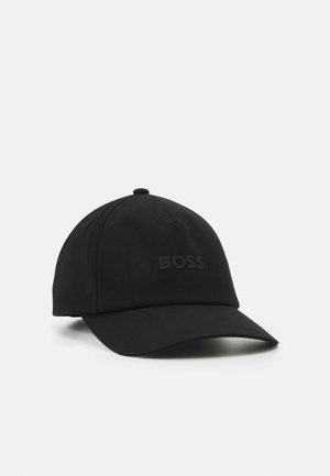 Black baseball cap with curved brim, featuring raised "BOSS" logo on the front, displayed on a plain light background.