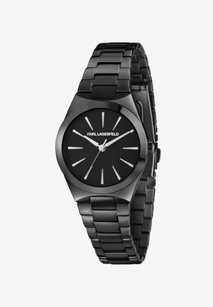 Montre noire en acier inoxydable avec un boîtier octogonal élégant, un cadran noir, des index argentés et un bracelet à maillons brillant. Design minimaliste.