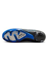 Black athletic shoe with a blue and white sole, featuring a textured upper, contoured design, and "ZOOM" branding on the outsole.