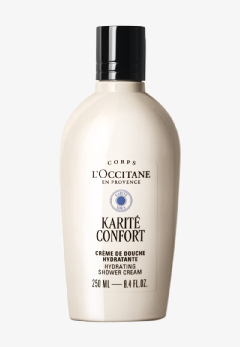 L'Occitane Karité Confort återfuktande duschkräm i en slät, oval, krämfärgad flaska med svart flip-top-kapsyl och etikett med detaljer. 250 ml.