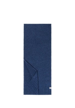 Dark blue knitted scarf folded at one corner with ribbed edges and a small white fabric brand label.