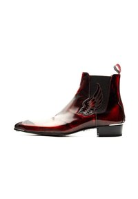 Red leather ankle boot with a glossy finish, pointed toe, elastic side panels, and a decorative wing emblem on the outer side.