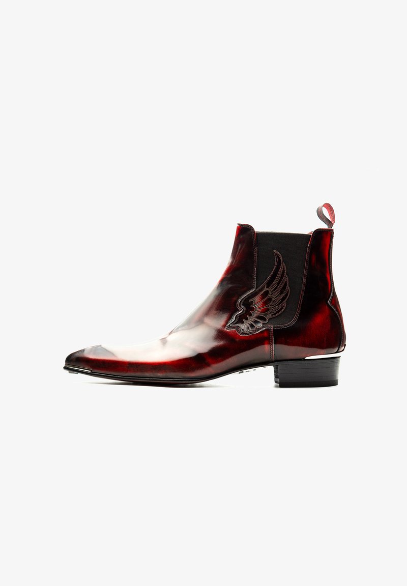 Red leather ankle boot with a glossy finish, pointed toe, elastic side panels, and a decorative wing emblem on the outer side.