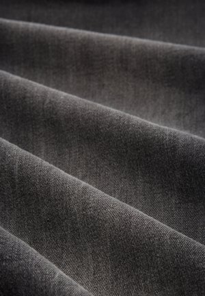Un material textil de culoare gri închis, cu o textură moale, prezentat în pliuri. Țesătura este strânsă, evidențiind o suprafață netedă și uniformă.