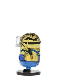 A colorful, geometric sculpture resembling a character with a yellow head, black gloves, and a blue base, displaying playful design elements.