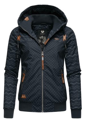 Dark blue jacket with polka dot and chevron patterns, featuring a zip front, hood, and leather accents on zippers and sleeves.