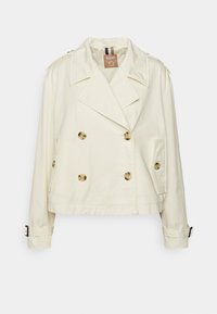 Veste courte crème à double boutonnage avec larges revers, épaulettes boutonnées, poches latérales et poignets ajustables avec boucle.