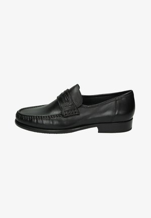 Schwarze Leder-Brogues mit abgerundetem Zehenbereich, genähten Details und einem dekorativen Riemen über dem Rist. Niedriger, strukturierter Gummisohle.
