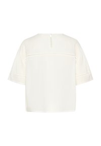 Weiße kurzärmlige Bluse aus leichtem Stoff, mit Rundhalsausschnitt und einem Schlüsselloch-Detail im Rücken, das durch einen kleinen Knopf geschlossen wird.