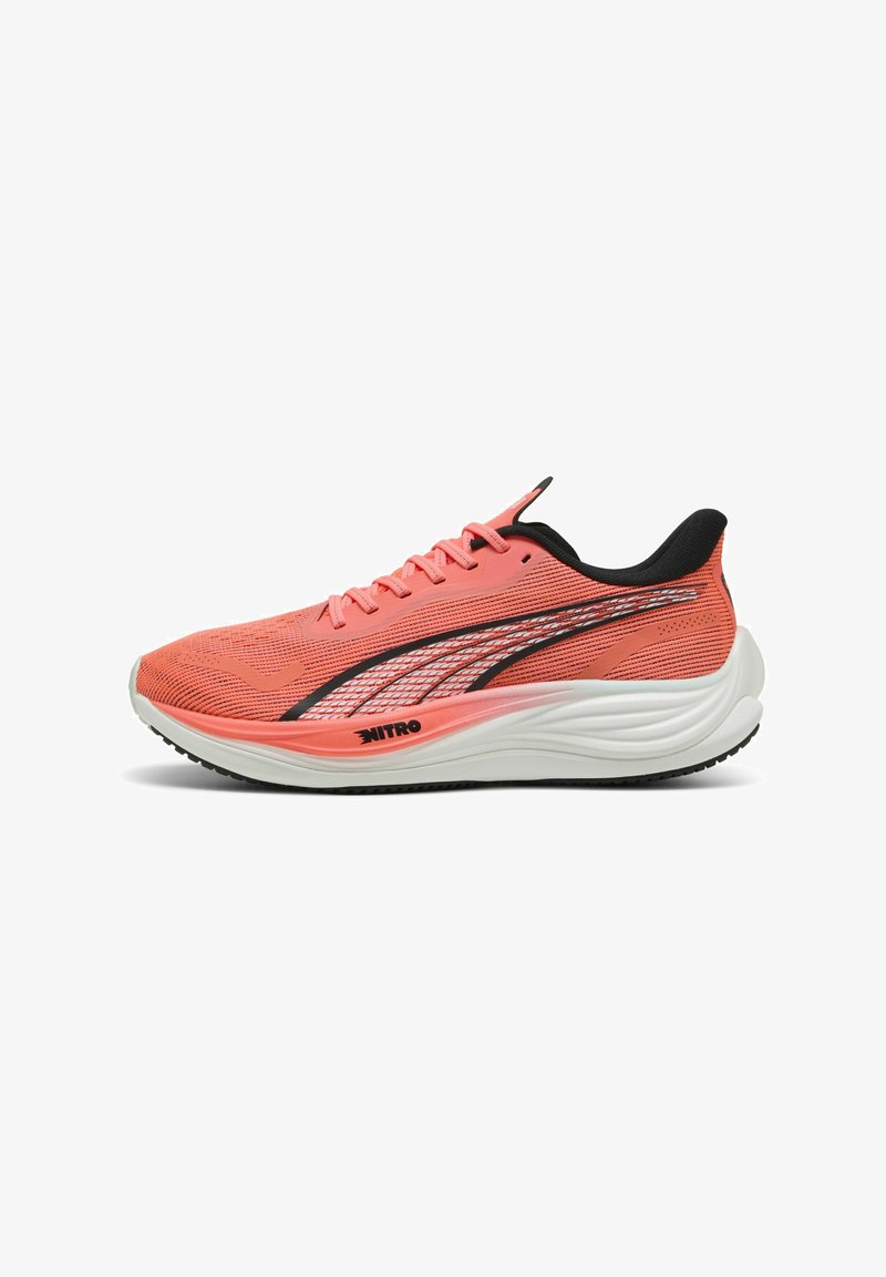 Zapatilla de correr en color coral con parte superior de malla, acentos negros, una entresuela blanca acolchada y suela exterior negra texturizada. Presenta un diseño elegante y aerodinámico.