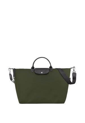 The bag features a large, rectangular design in dark green nylon, with a black leather trim and a top handle. It includes a detachable shoulder strap.