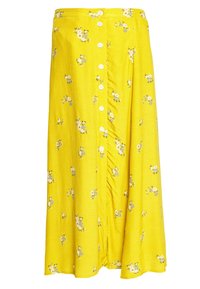 Jupe florale jaune en tissu texturé, dotée de boutons blancs sur le devant et ornée de petits motifs de fleurs bleu et blanc.