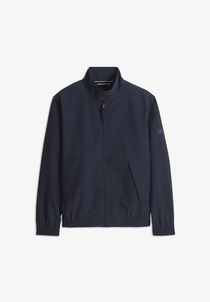 Giacca blu navy con zip frontale, colletto alla coreana, due tasche frontali inclinate, polsini elasticizzati e vita elasticizzata.