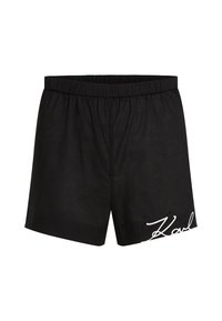 Shorts noirs en coton avec une taille élastique, arborant un logo brodé blanc. Design simple, longueur genou sans motifs supplémentaires.