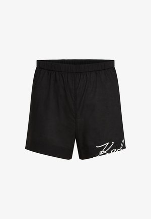Black cotton shorts with an elastic waistband, featuring a white embroidered logo. Simple design, knee-length with no additional patterns.