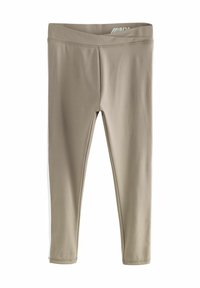 Leggings beiges en tissu extensible avec une texture lisse. Présentent une taille haute et des rayures latérales blanches contrastantes.