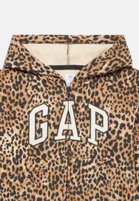 Felpa con zip frontale in stampa leopardata, grande lettering "GAP" in crema e una consistenza morbida. Presenta un cappuccio e tasche.