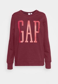 Sudadera de algodón burdeos con un gran logotipo degradado de "GAP" en el pecho, escote redondo y mangas largas con puños de canalé.