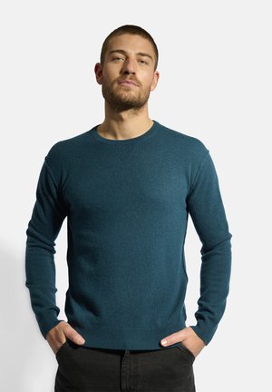Teal knit sweater with long sleeves and a round neckline, made from soft fabric; features ribbed cuffs and hem.