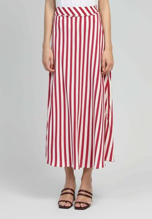 Jupe longue en A avec des rayures verticales rouges et blanches. Fabriquée en tissu léger, elle présente une taille haute et une fente pour un mouvement confortable.