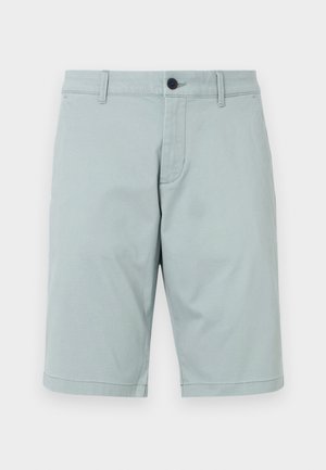 Világos teal színű, sima anyagból készült rövidnadrág, lapos elülső résszel, két oldalsó zsebből és egy gombos zárással. Tiszta, igényes dizájn.