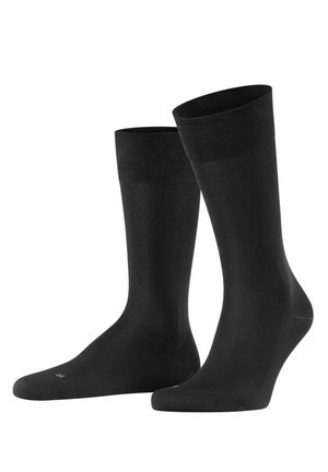 Black ankle socks made from textured fabric, featuring a ribbed cuff, smooth body, and reinforced toe for durability.