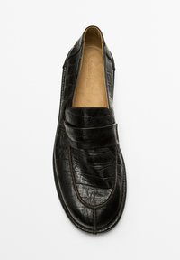Black leather moccasin shoe with a textured finish and a strap across the top, displayed against a plain white background.