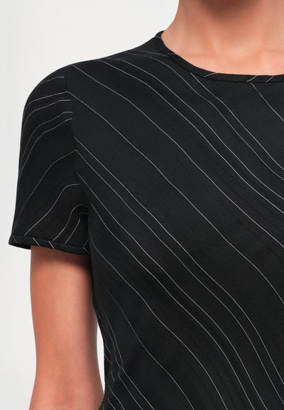 Black top with short sleeves featuring white diagonal stripes, a round neckline, and a smooth texture.