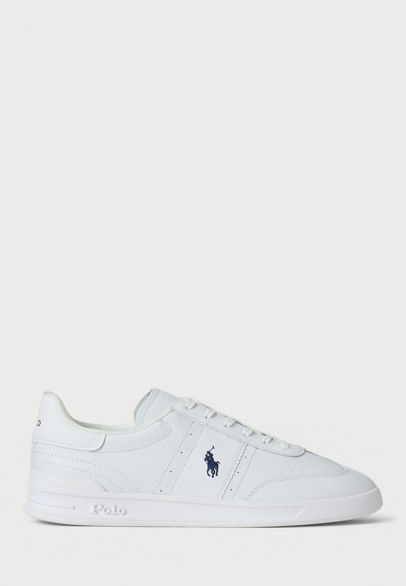 White sneakers made of synthetic material, featuring a smooth texture, lace-up design, and a blue logo accent on the side.