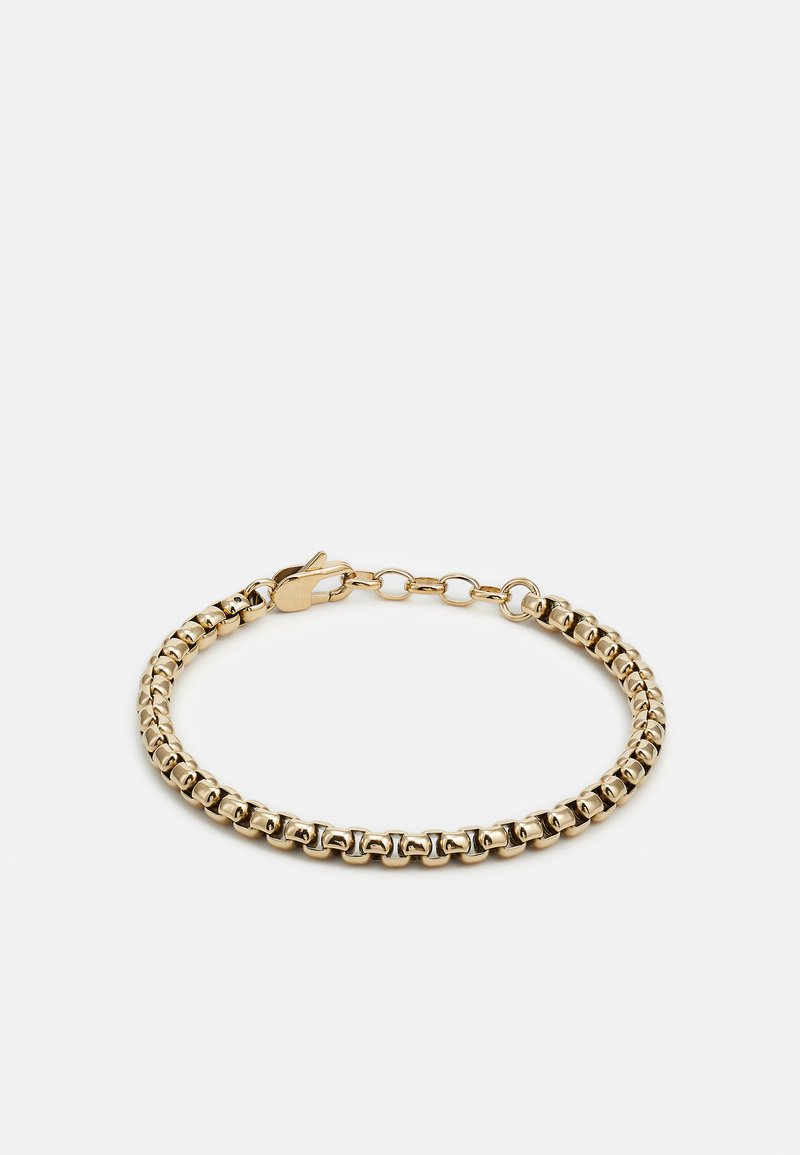 Bracelet doré composé de pièces ovales liées ayant une texture lisse. Il dispose d'un fermoir à ressort et d'une chaîne ajustable pour le dimensionnement.