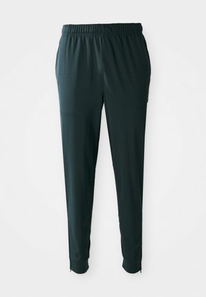 Pantaloni da track leggeri di colore verde scuro, con vita elastica, tasche laterali e zip alla caviglia per una vestibilità regolabile; texture liscia.