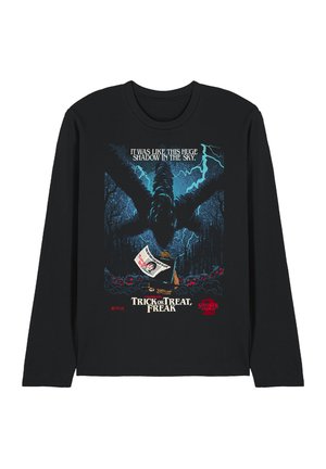 Dark long-sleeve shirt with a large shadowy monster, lightning, a person holding a sign, and text "Trick or Treat, Freak" from Stranger Things.