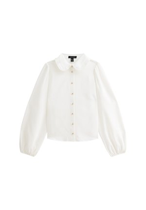 Blouse blanche avec col en Peter Pan, manches longues à volants, et boutons dorés sur le devant. Tissu lisse avec un léger éclat.