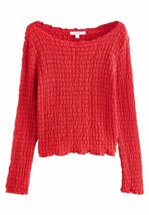 Pull en maille rouge à manches longues avec une texture, un bord légèrement festonné et un col rond, présenté sur fond blanc.