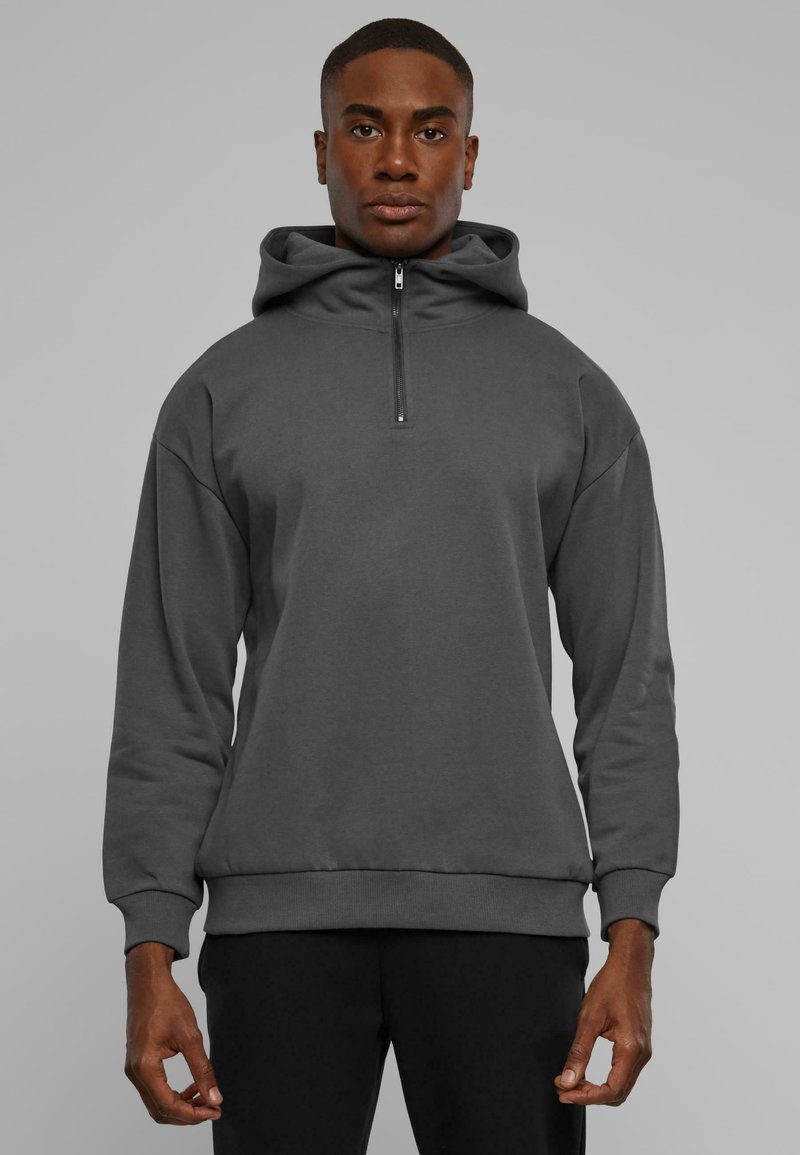 Mørkegrå zip-up hoodie lavet af glat stof, med hætte, lange ærmer og ribbede mansjetter og kant. Standard pasform med afslappet design.