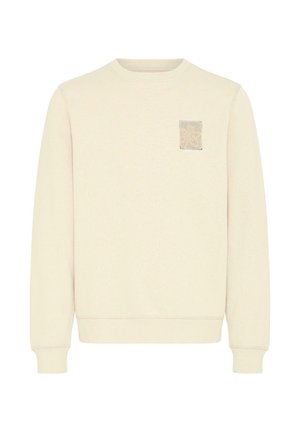 Cremefarvet sweatshirt med rund hals, lange ærmer og et tekstureret mærke på venstre brystområde. Blødt stof og tilpassede ærmekanter.