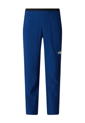 Blå tætsiddende sportsbukser med sort elastisk talje og The North Face-logo på højre lår, set fra front.