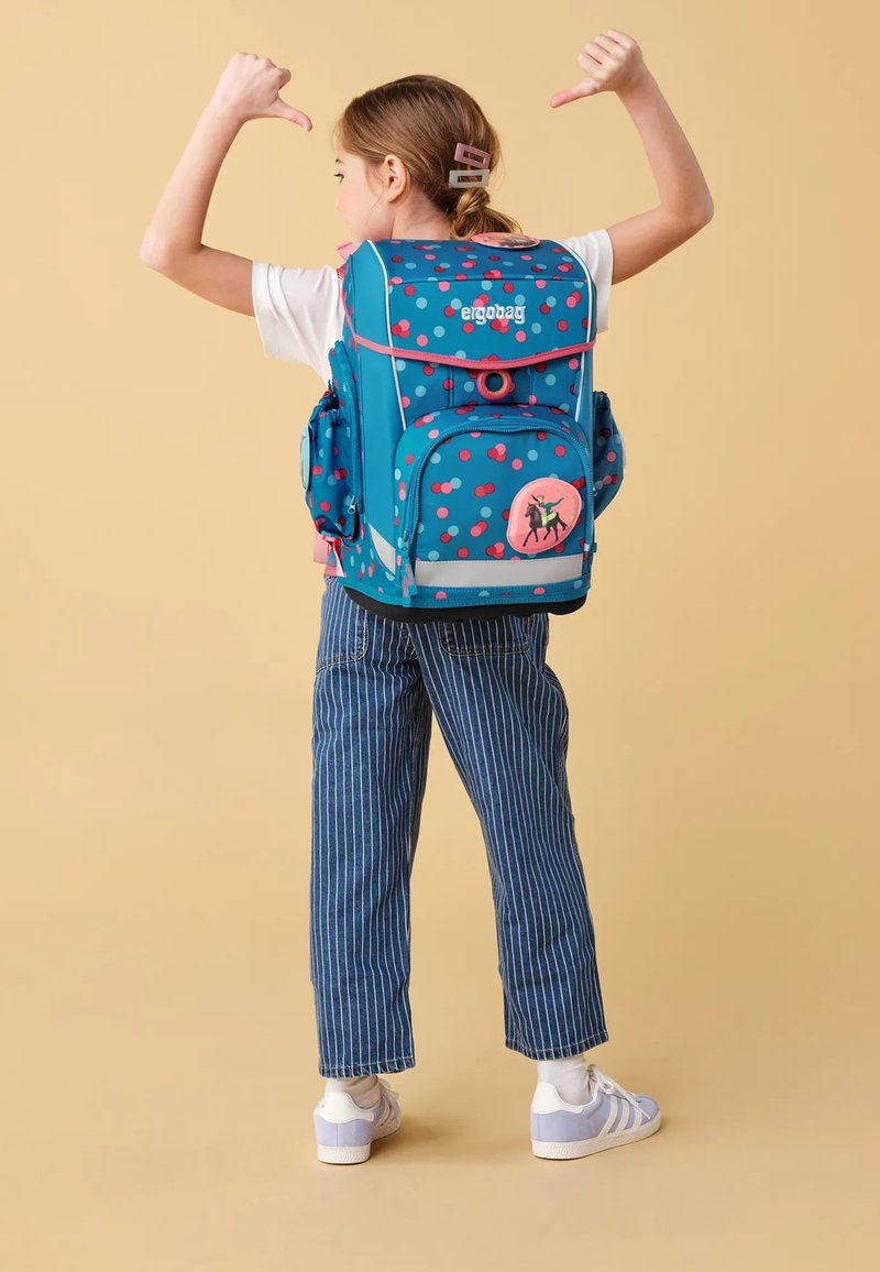 Blue backpack with multicolored polka dots, padded straps, multiple compartments, and a pink emblem featuring a horse.