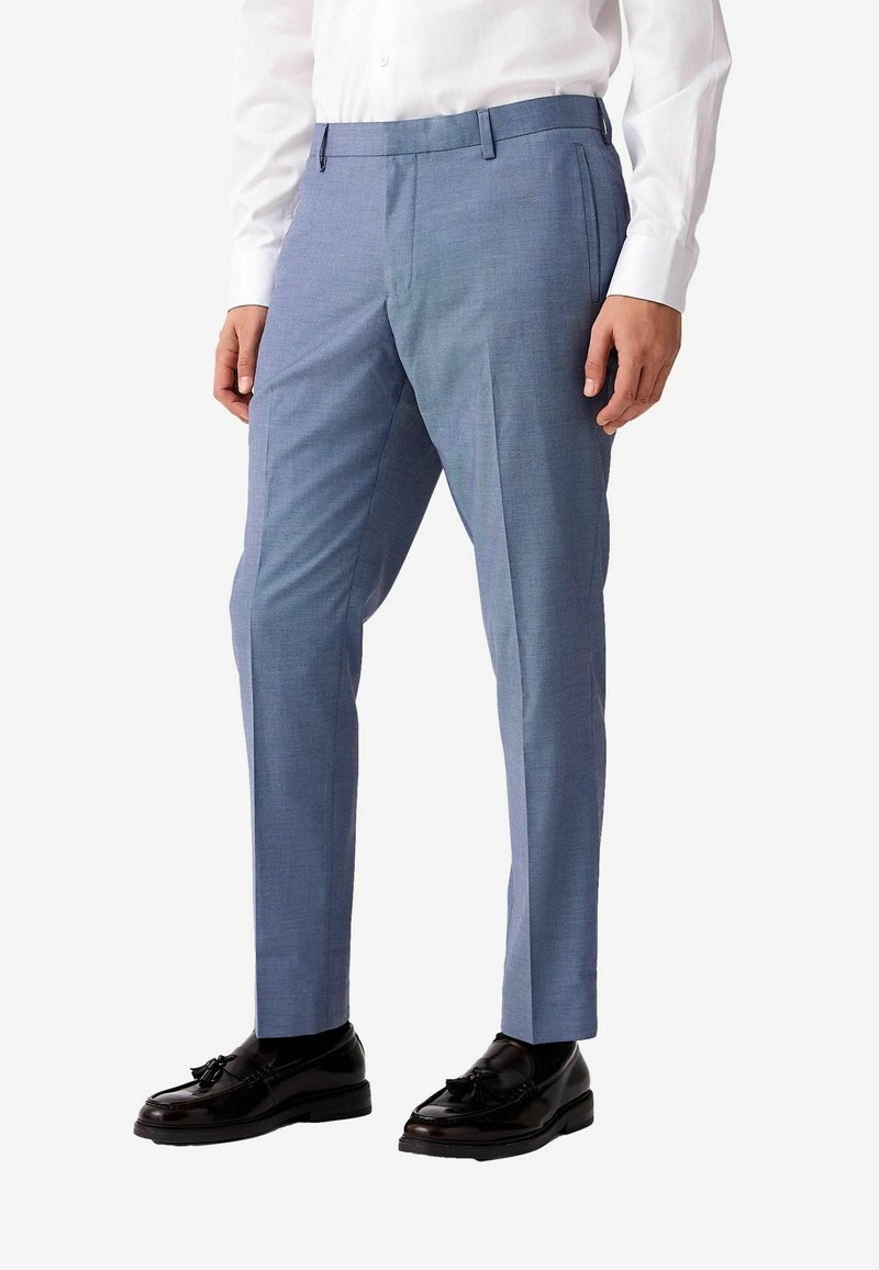 Light blue tailored trousers with a smooth texture, featuring a flat front, side pockets, and subtle crease lines, paired with black shoes.