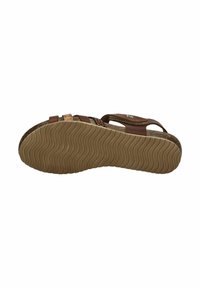 Brown sandal with textured cork footbed, multiple straps, and a flexible rubber sole featuring a wavy tread pattern.